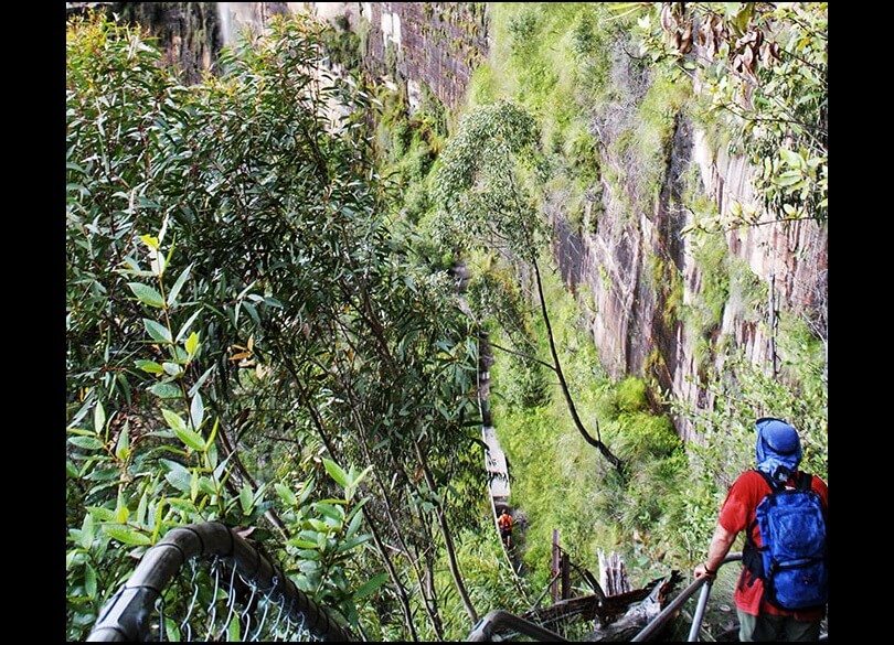 Bushwalker wearing backpack Govetts Leap descent Rodriguez Pass Blue Mountains National Park