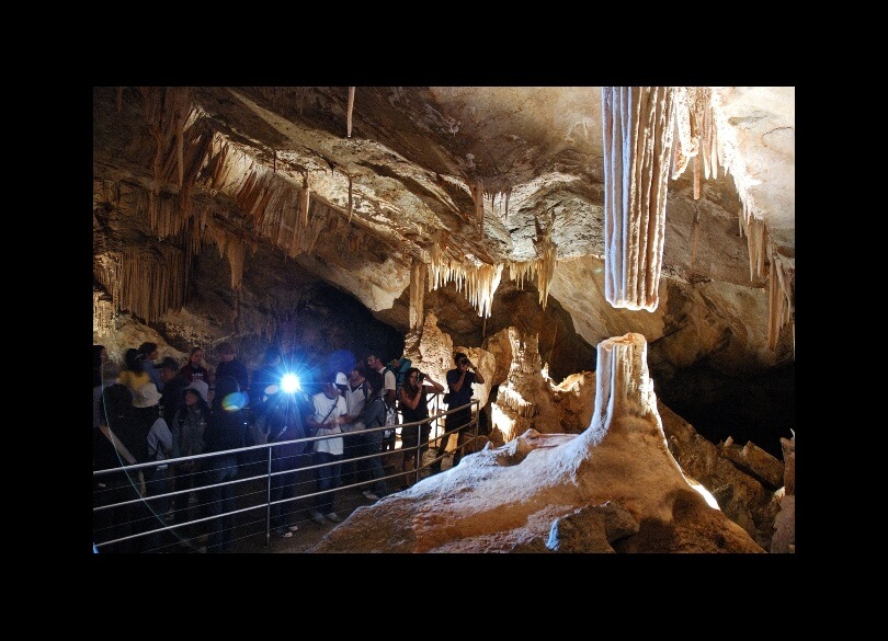 Group of people looking at Broken Column, Lucas Cave, Jenolan Caves