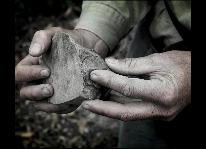 Eric Keidge holds a stone tool fitted back together during a visit to an Aboriginal site in Oxley Wild Rivers National Park, Anaiwan/Gumbaynggirr Country. 