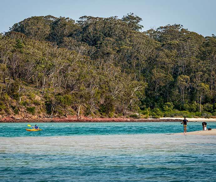 Tourists enjoy fishing and kayaking in Ben Boyd National Park