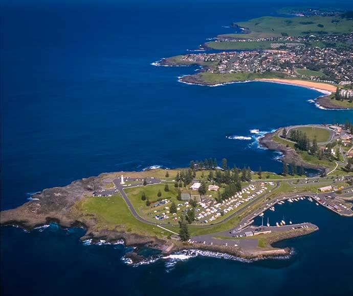 Aerial view, Kiama Harbour Light is an active lighthouse at Blowhole Point, south of Kiama Harbour