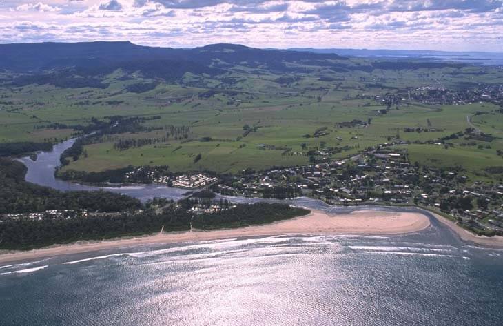 A view of Crooked River meeting the sea surrounded by Seven Mile Beach and the town of Gerrora