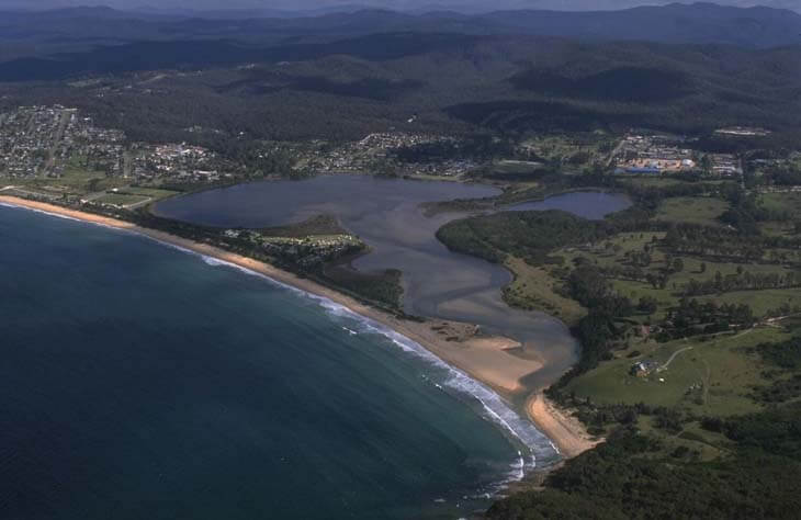 A view of Curalo Lagoon with the township of Eden in the background and Aslings Beach in the foreground