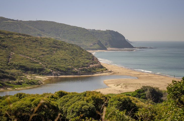 A view of Glenrock lagoon, with the beach and ocean in the background