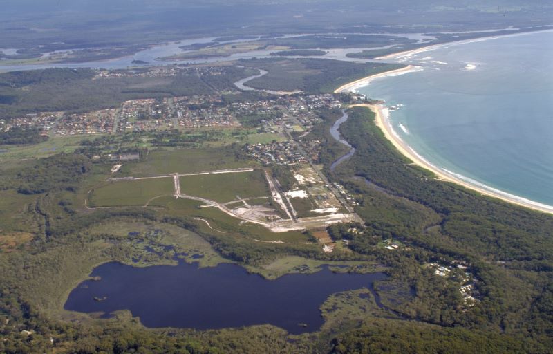 Aerial view showing large saltwater lagoon feeding into a small creek and then out to an estuary at South West Rocks, NSW