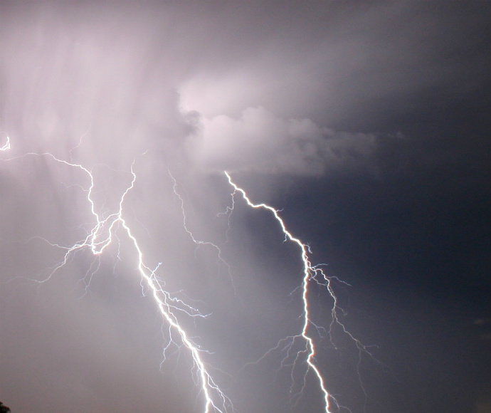 Lightning bolts in a grey sky.