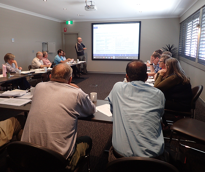 Macquarie-Cudgegong Environmental Water Advisory Group meeting, with the group sitting around tables as an Office of Environment and Heritage staff member delivers a presentation.