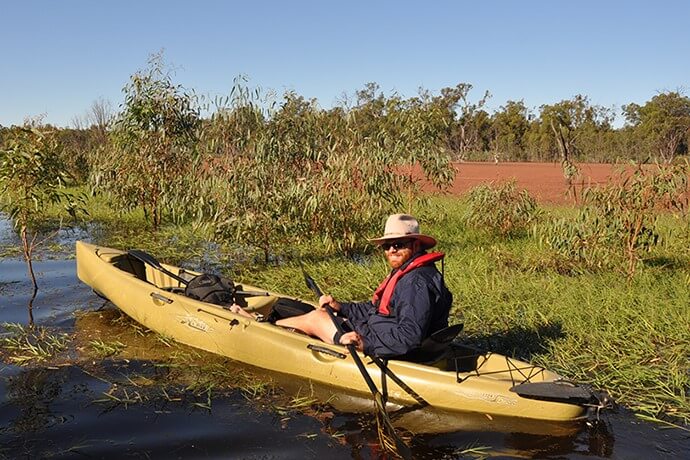 DCCEEW staff inspecting a lagoon from canoe in the Murrumbidgee