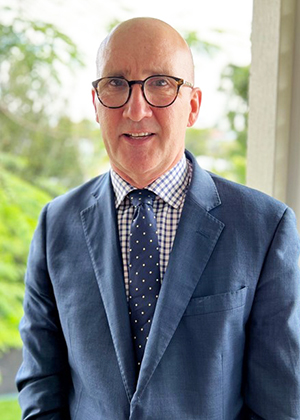 Person in a blue suit with a checkered shirt and polka dot tie