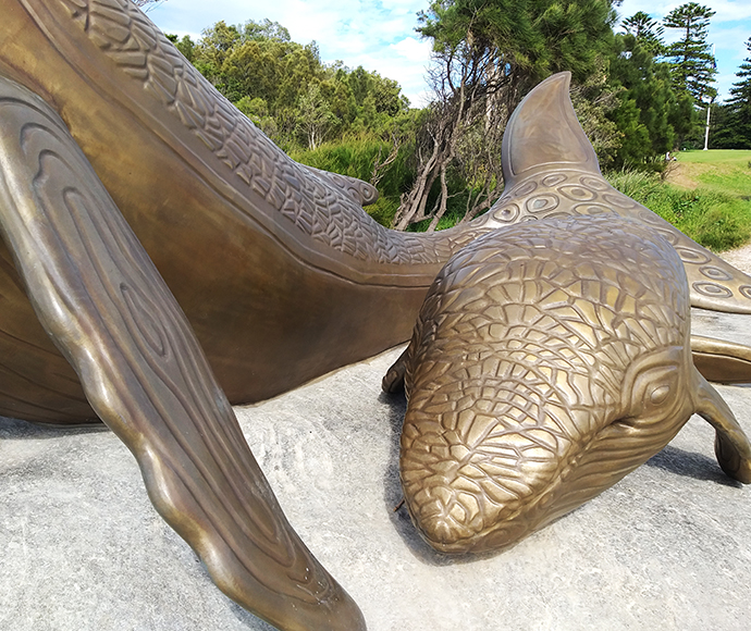 Kurnell Whale Sculptures - First View: Side view of whale bone-like sculptures along the coast at Kurnell in Kamay Botany Bay National Park. These sculptures honor Aboriginal culture and connect visitors to the region’s natural history.