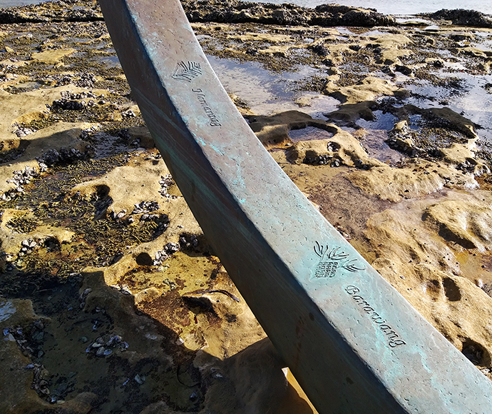 The Eyes of the Land and the Sea - Close-up: A detailed view of one of "The Eyes of the Land and the Sea" sculptures, depicting stylized, interconnected eye shapes. This artwork represents the connection between land and sea in Aboriginal culture.