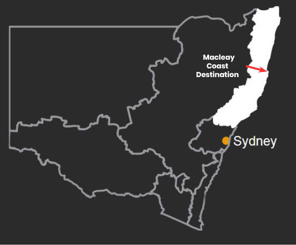 A simple black and white map. A red arrow points out Macleay Coast Destination, while an orange dot points out Sydney. This map demonstrates that Macleay Coast Destination is north of Sydney.