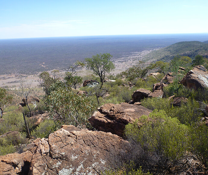 Photograph of the Valley of the Eagles Walk in Gundabooka National Park, featuring a scenic trail with rocky outcrops, native vegetation, and expansive views of the surrounding landscape.