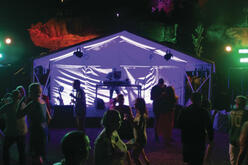 New Year's Eve celebrations with a tent set up for the DJ, and people dancing at Clark Island Sydney Harbour National Park